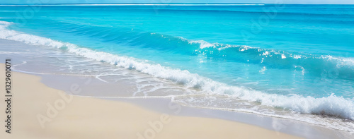 Beautiful beach waves background in summer. Light blue transparent water waves with sun light and sandy beach. Summer vacation background.