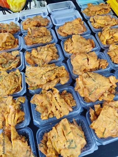 Vendor selling cuisine at street bazaar in Malaysia catered for iftar during Muslim fasting month of Ramadan