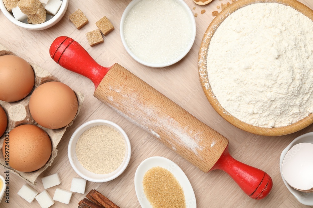 Rolling pin and different ingredients on wooden table, flat lay Rolling pin and different ingredients on wooden table, flat lay