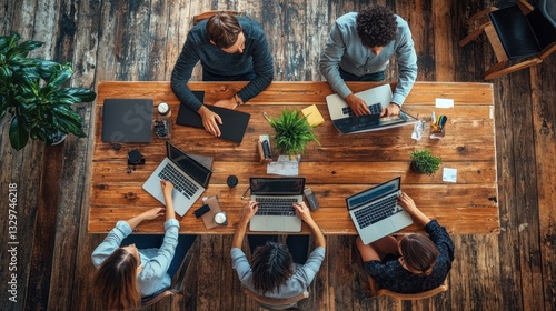 Teamwork, Collaboration, and Modern Office Space: Aerial View of Diverse Professionals Working Together on Laptops at a Rustic Wooden Table