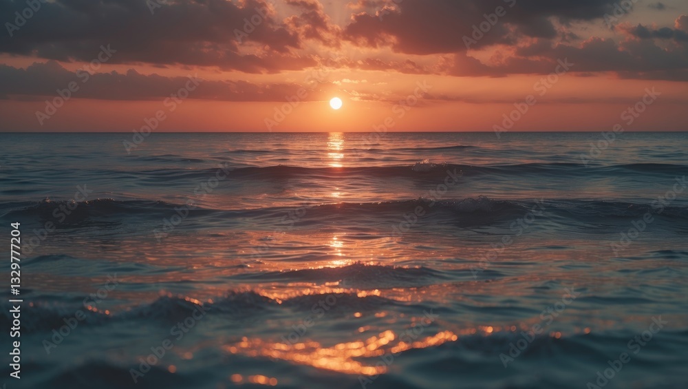 Obraz premium The evening sun reflects off the calm surface of the sea. The ocean's warm tones are truly authentic. Sunset above a bubbly sea of small waves. Dawn lit up the ocean. Beautiful scenery.