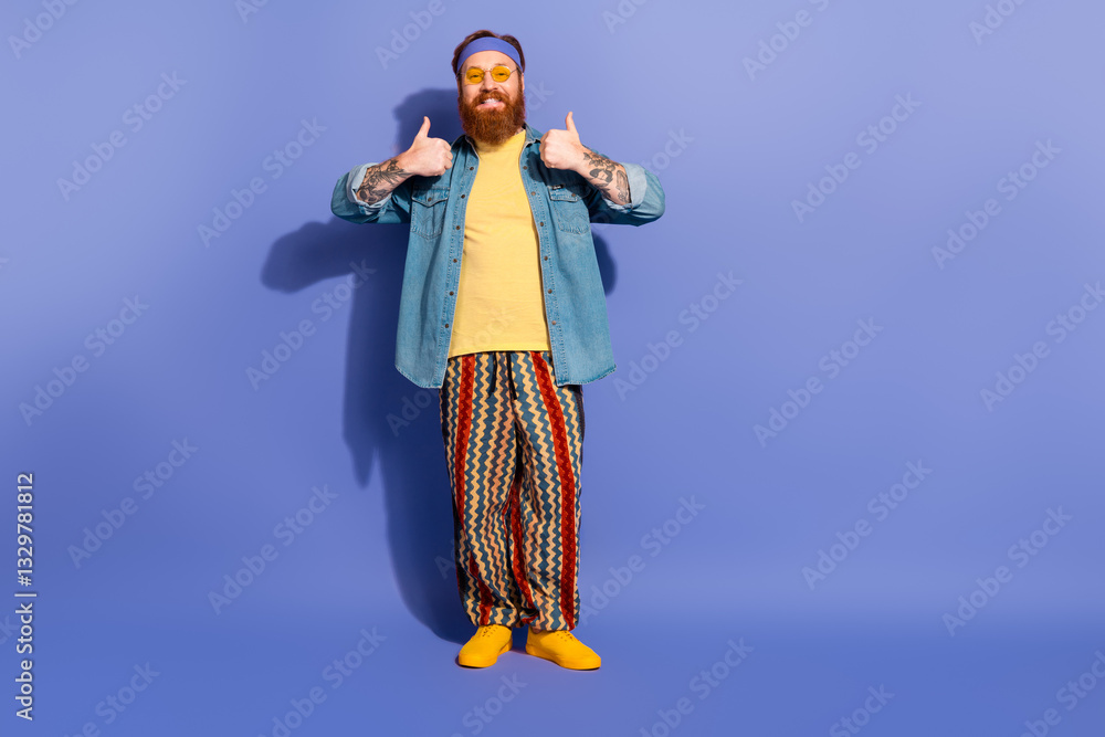 Fototapeta premium Stylish man with a beard in vibrant attire giving thumbs up against a purple background