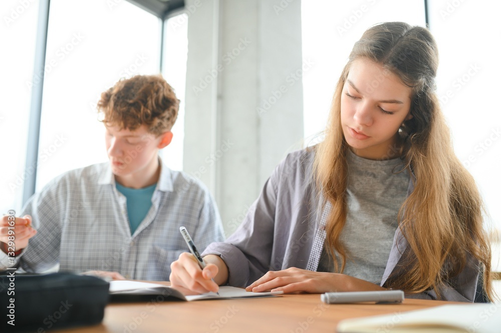 Group of college students doing homework Group of college students doing homework
