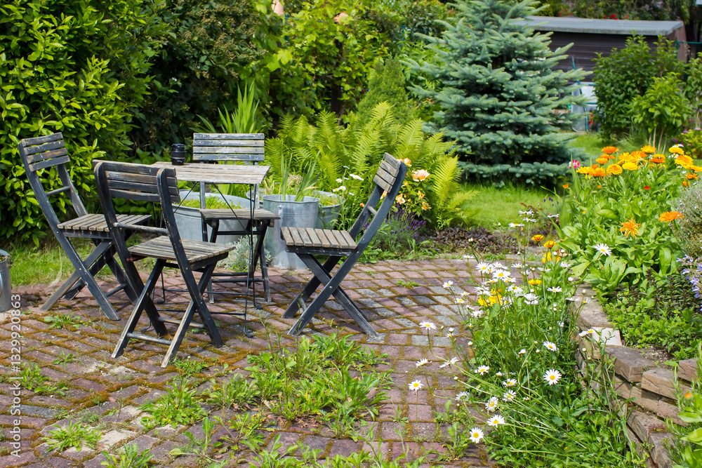 erb spiral in the garden and table with chairs