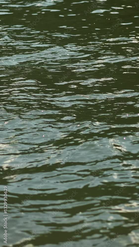 Rippling lake surface with small waves view from sailing boat closeup. River water on calm summer day during motorboat trip. Recreational time in nature Rippling lake surface with small waves view from sailing boat closeup. River water on calm summer day during motorboat trip. Recreational time in nature