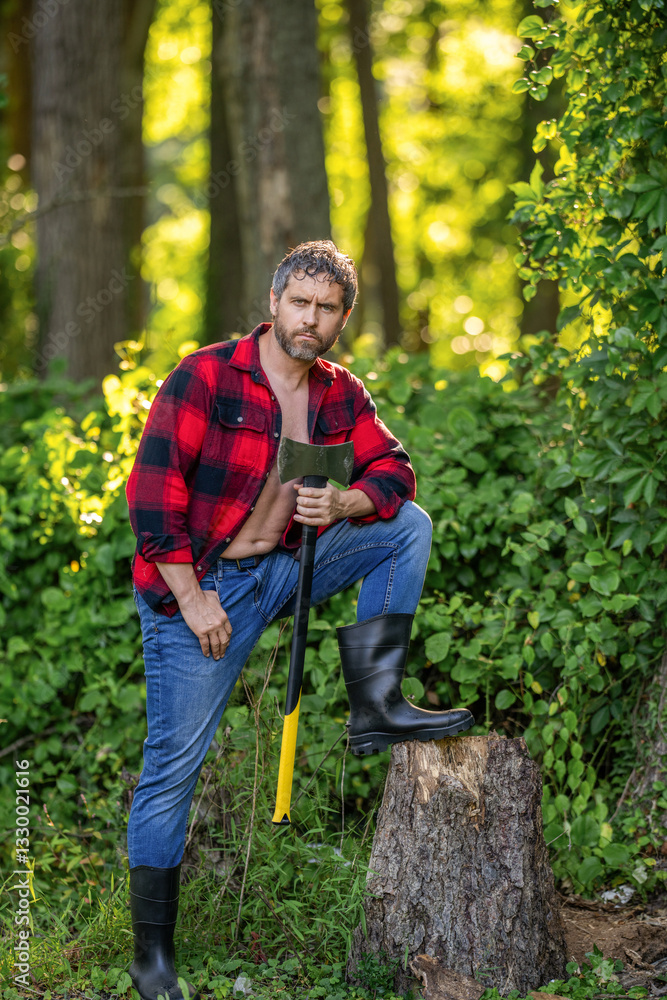 Hispanic man logging with axe in rubber boots. Lumberjack axe. Man with logging axe. Hardworking brutal man. Logging lumberjack man outdoor. Brutal lumberjack. Brutality and masculinity Hispanic man logging with axe in rubber boots. Lumberjack axe. Man with logging axe. Hardworking brutal man. Logging lumberjack man outdoor. Brutal lumberjack. Brutality and masculinity
