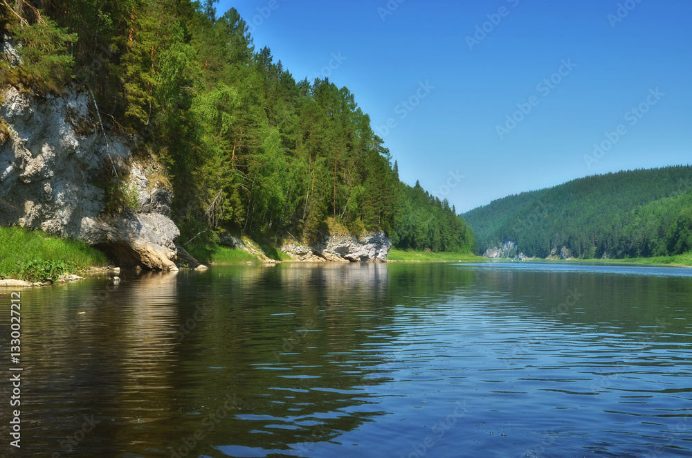 Fototapeta premium The natural landscape of the rocky shore of the Chusovaya River in the Perm region of Russia in summer.
