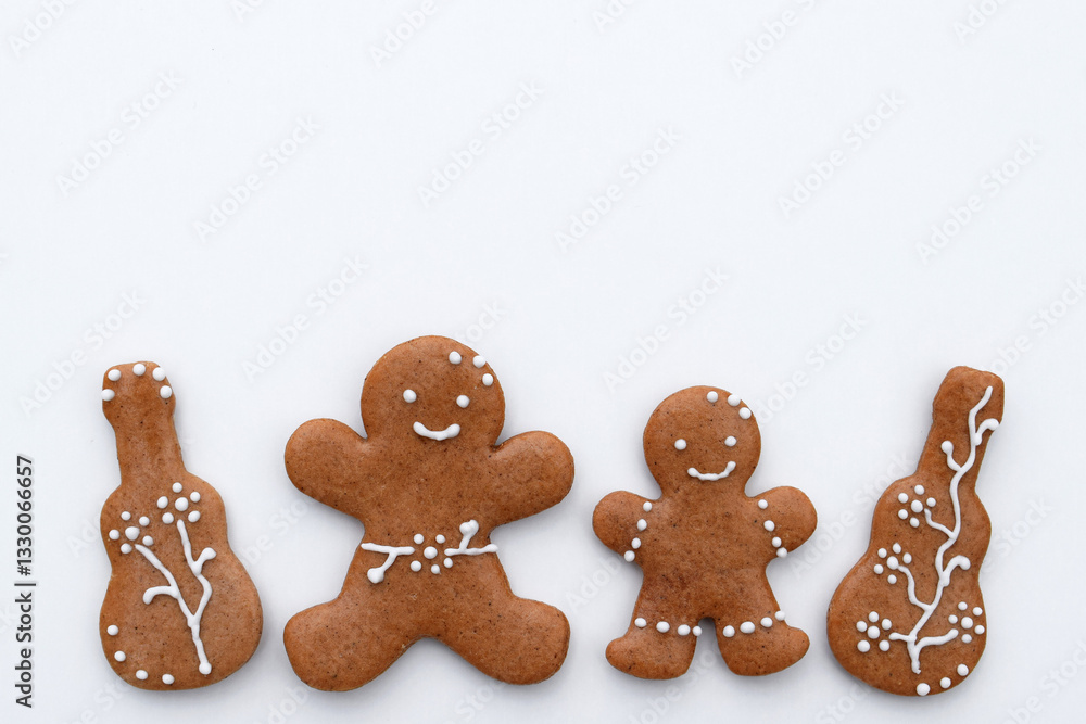 Romantic decorated gingerbread cookies in a shape of guitar and man, white background, copy space for text. Musical theme Romantic decorated gingerbread cookies in a shape of guitar and man, white background, copy space for text. Musical theme