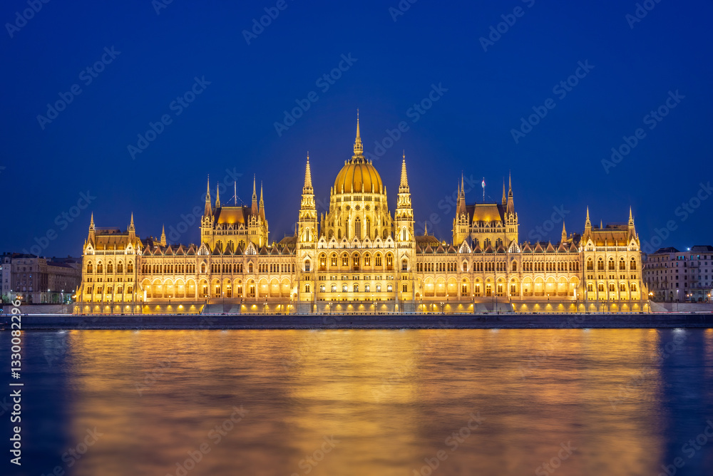 Budapest parliament illuminated at night and Danube river, Hungary