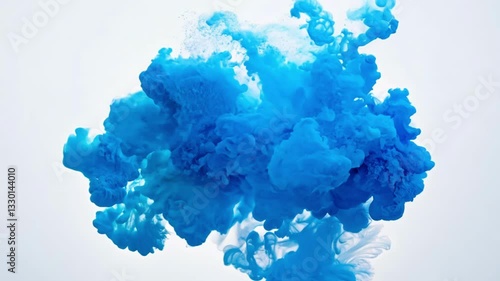 Vibrant blue paint or paint dissolving in water creating flowing abstract patterns. The intense azure liquid expands in mesmerizing cloud-like formations against white background with fluid motion.