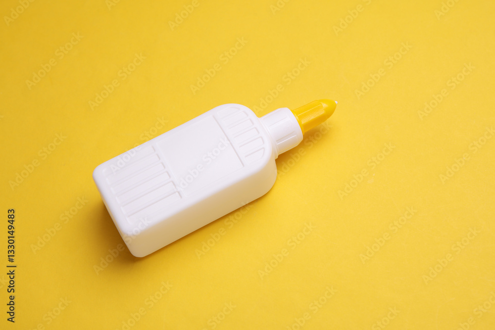 Bottle of PVA glue on a yellow background Bottle of PVA glue on a yellow background