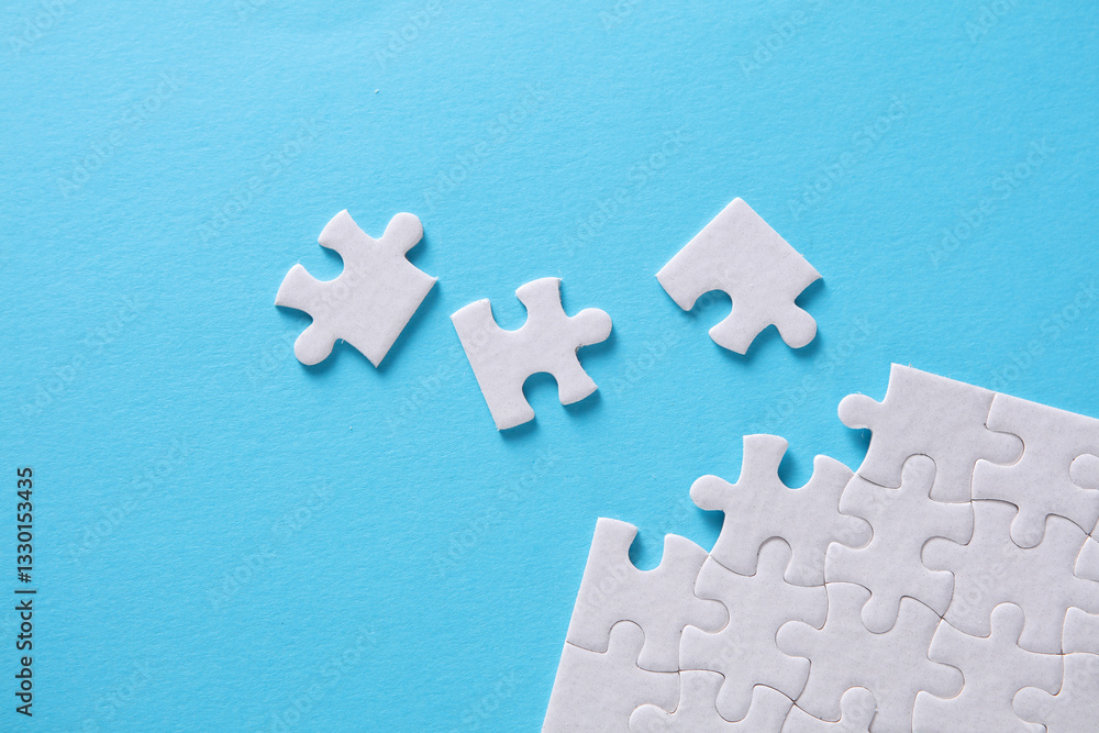 White blank square Jigsaw puzzle pieces disassembled.on blue background. Mockup for design White blank square Jigsaw puzzle pieces disassembled.on blue background. Mockup for design