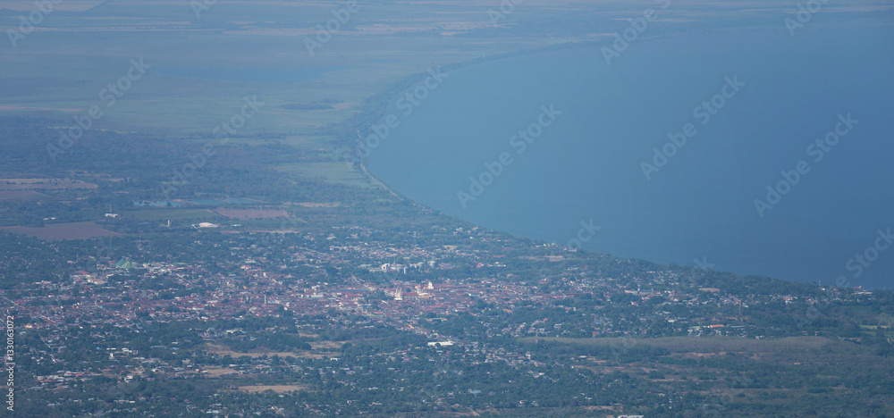 View of a coastal town beside a vast lake, showcasing natural beauty from above View of a coastal town beside a vast lake, showcasing natural beauty from above