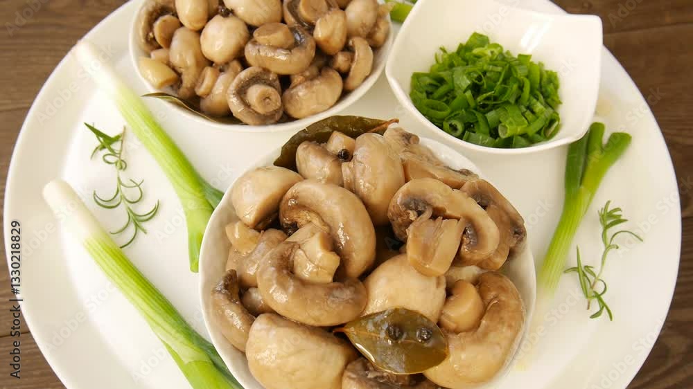 Pickled mushrooms champignons on a plate. Pickled mushrooms champignons on a plate.