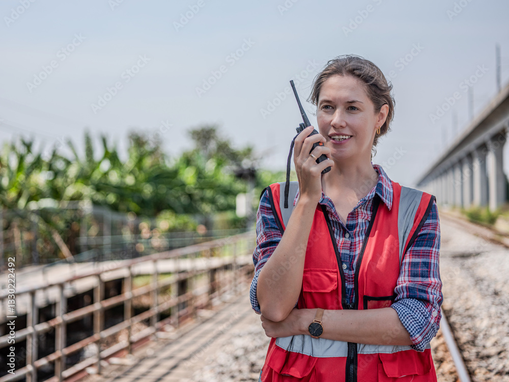 Construction workers use walkie-talkies for project management, planning or communication via tablets. Architects, contractors or engineering professionals are happily