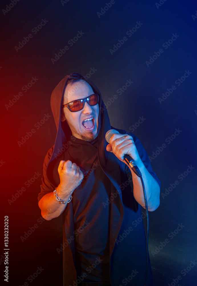 Rock singer man sings with microphone and sunglasses Rock singer man sings with microphone and sunglasses