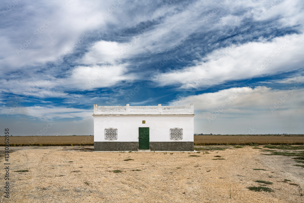 White Rural House Surrounded by Fields in Isla Mayor Countryside, Sevilla, Spain White Rural House Surrounded by Fields in Isla Mayor Countryside, Sevilla, Spain