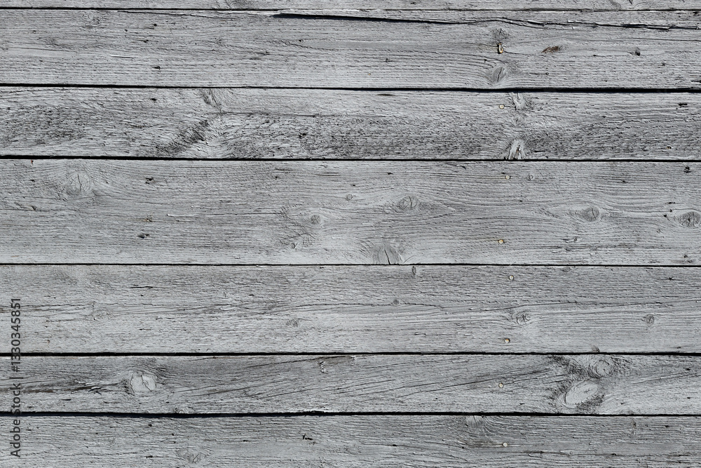 The texture of gray from old wooden planks arranged in a vertical order. Background for further design. Ancient building material. Rough relief texture of natural wood. Combustible insulating surface The texture of gray from old wooden planks arranged in a vertical order. Background for further design. Ancient building material. Rough relief texture of natural wood. Combustible insulating surface