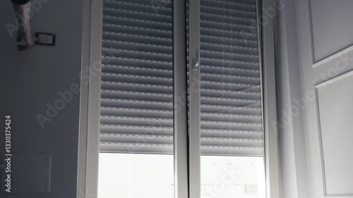 Smart Home Convenience Man Controls Roller Shutter with Wall Switch