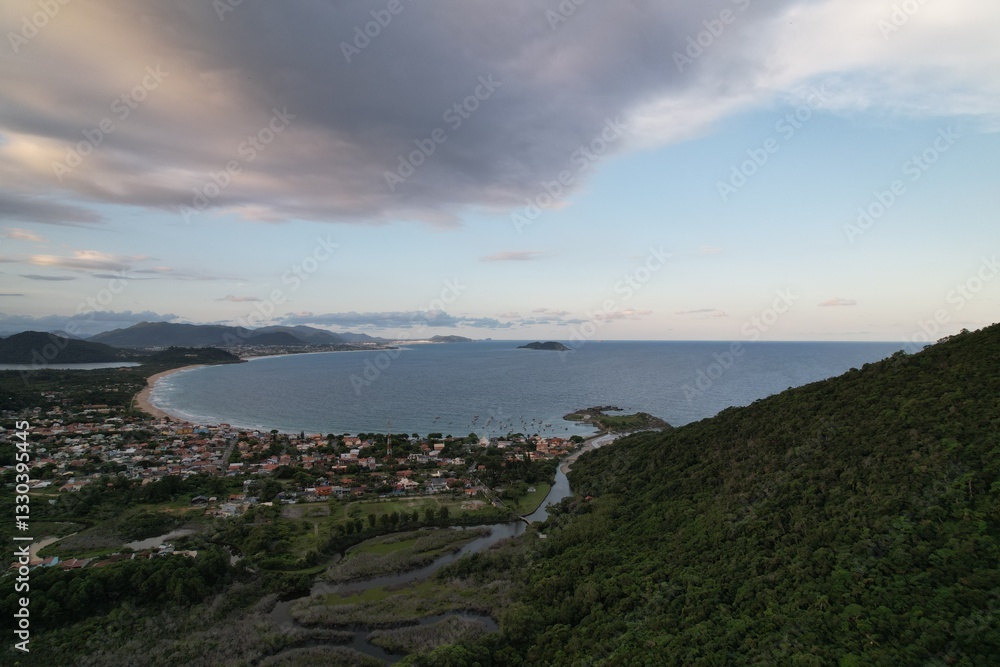Fototapeta premium Stunning coastal view from a hill overlooking the bay near a small town