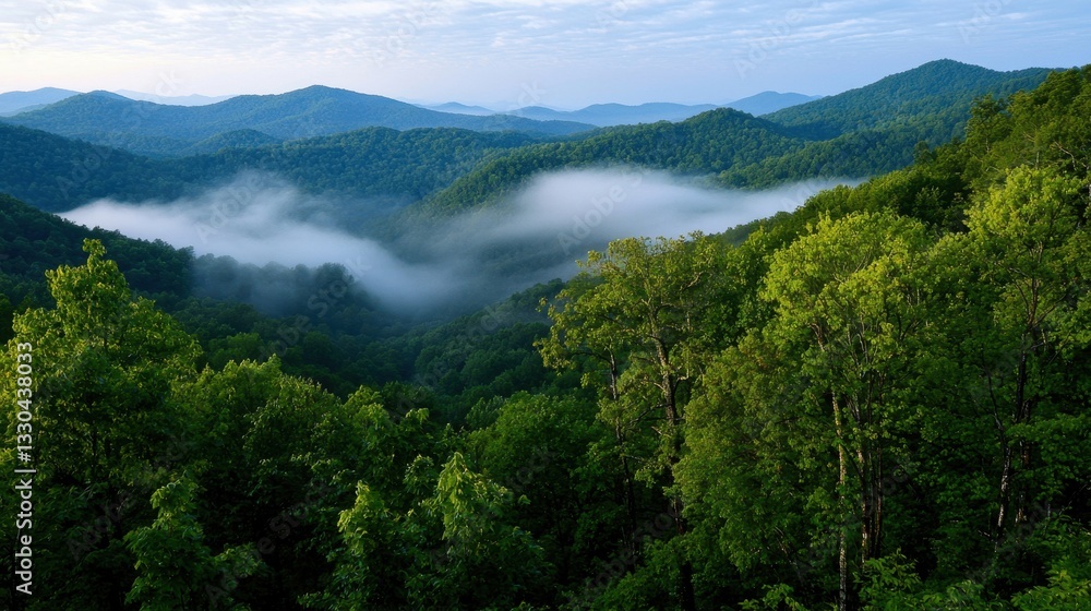 Lush green mountains rise majestically in the background. Fog gently swirls in the valley, creating a serene atmosphere in the early morning light Lush green mountains rise majestically in the background. Fog gently swirls in the valley, creating a serene atmosphere in the early morning light