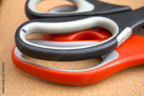 two pairs of scissors in red and black colors side by side