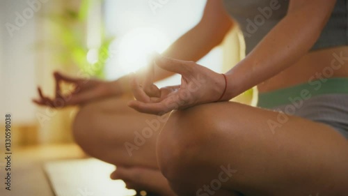 Wallpaper Mural A woman sits cross-legged while practicing yoga meditation, focusing on her breath in a tranquil indoor space filled with natural light and plants Torontodigital.ca
