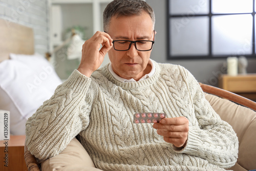 Middle-aged man reading pil...
