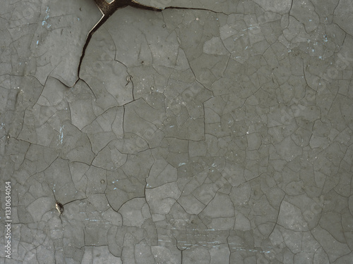 Peeling paint on the wall. Old concrete wall with cracked flaking paint. Weathered rough painted surface with patterns of cracks and peeling. Grunge texture for background and design. Closeup