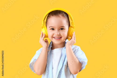 Cute little girl in headpho...