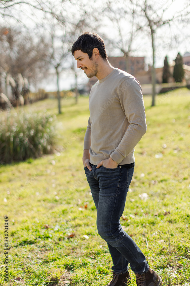 A middle-aged Caucasian man walks through a sunlit park, looking to the side with a peaceful and natural expression. Carefree moment. Full-body shot, vertical, blurred background with trees and grass A middle-aged Caucasian man walks through a sunlit park, looking to the side with a peaceful and natural expression. Carefree moment. Full-body shot, vertical, blurred background with trees and grass