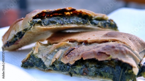 slices of erbazzone, also known as scarpazzone, is a typical Italian gastronomic specialty of Reggio Emilia, savory pie made with chard or spinach