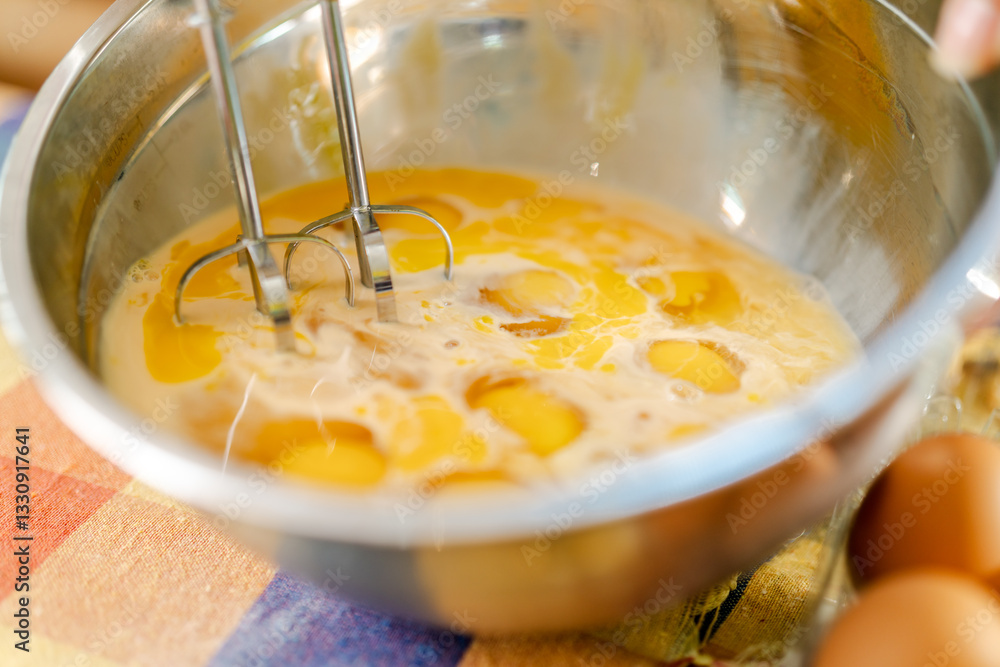 Pastry chef whisking eggs in bowl for baking recipe Pastry chef whisking eggs in bowl for baking recipe