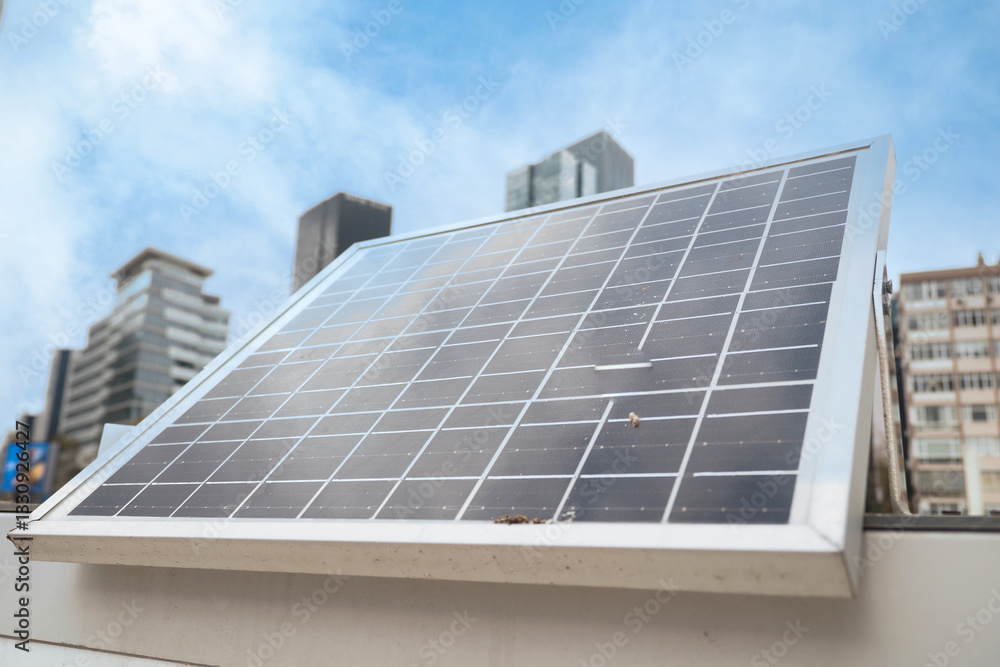 Fototapeta premium Solar panel installation on rooftop in an urban setting