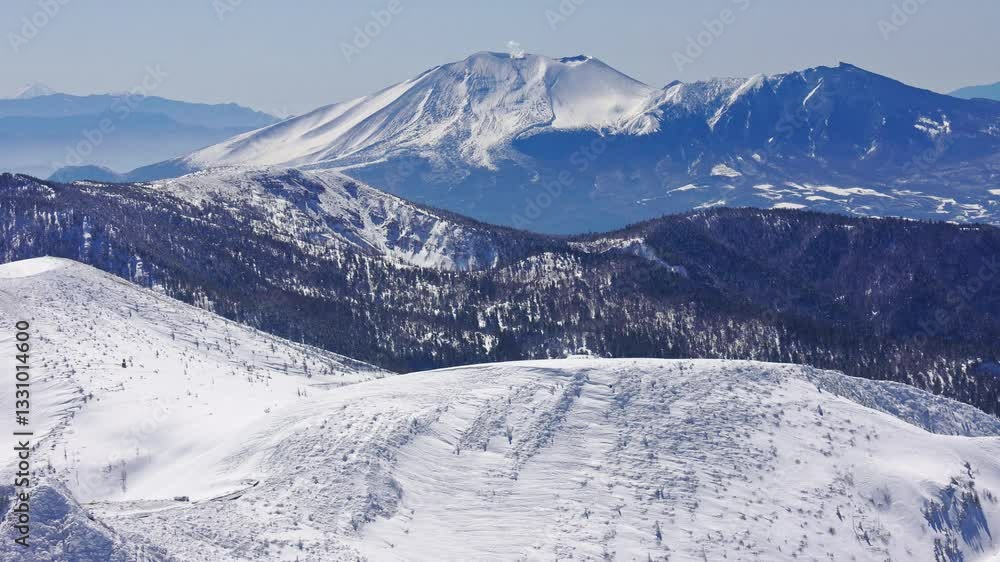Snow covered steaming volcano Mount Asama in Nagano, Japan. Handheld shot Snow covered steaming volcano Mount Asama in Nagano, Japan. Handheld shot
