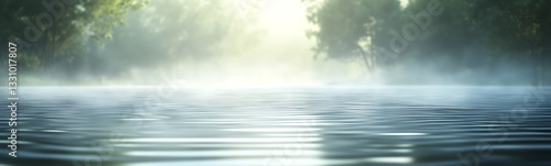 Serene water surface reflecting mist and soft light in a tranquil natural setting.
