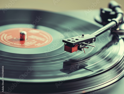 Vinyl record player detail:  arm poised over spinning disc, playing music photo