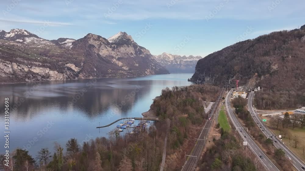 Walensee, Switzerland breathtaking aerial view, pristine lake, winding highways, railway tracks and stunning Swiss alps. Walensee, Switzerland breathtaking aerial view, pristine lake, winding highways, railway tracks and stunning Swiss alps.
