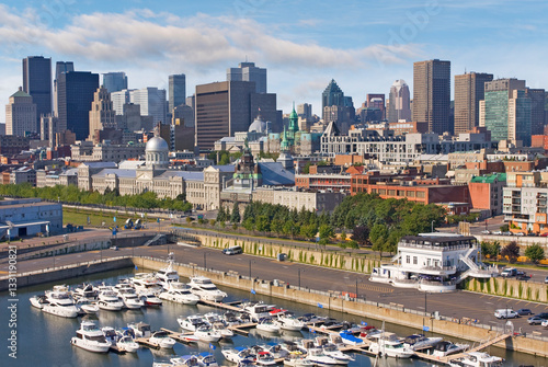 Aerial view of Montreal skyline in summer with yachts port in the foreground
