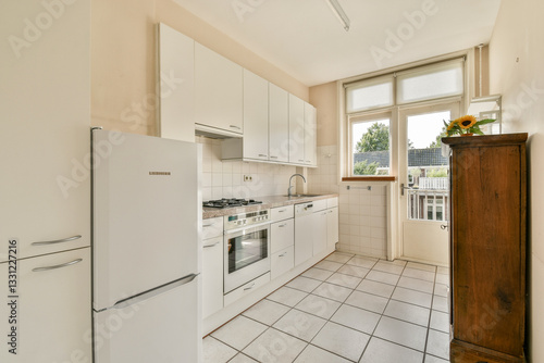 A bright and airy kitchen featuring white cabinets, stainless steel appliances, and a clean layout, perfect for modern living. The natural light enhances the space.