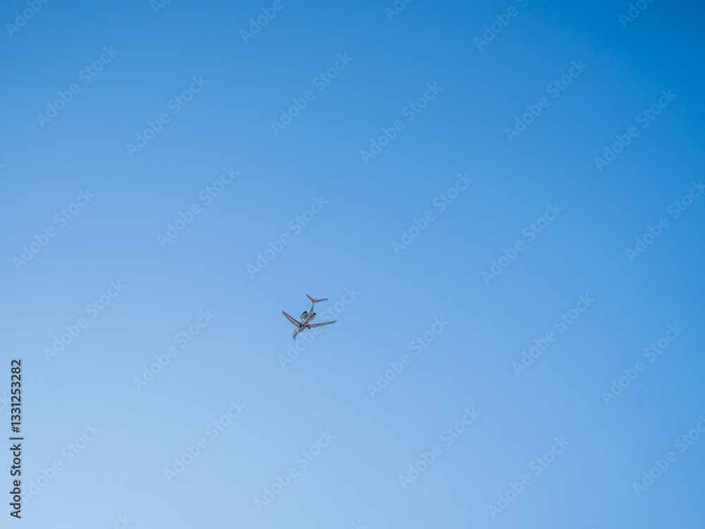 Airplane flying in clear blue sky with minimal background Airplane flying in clear blue sky with minimal background