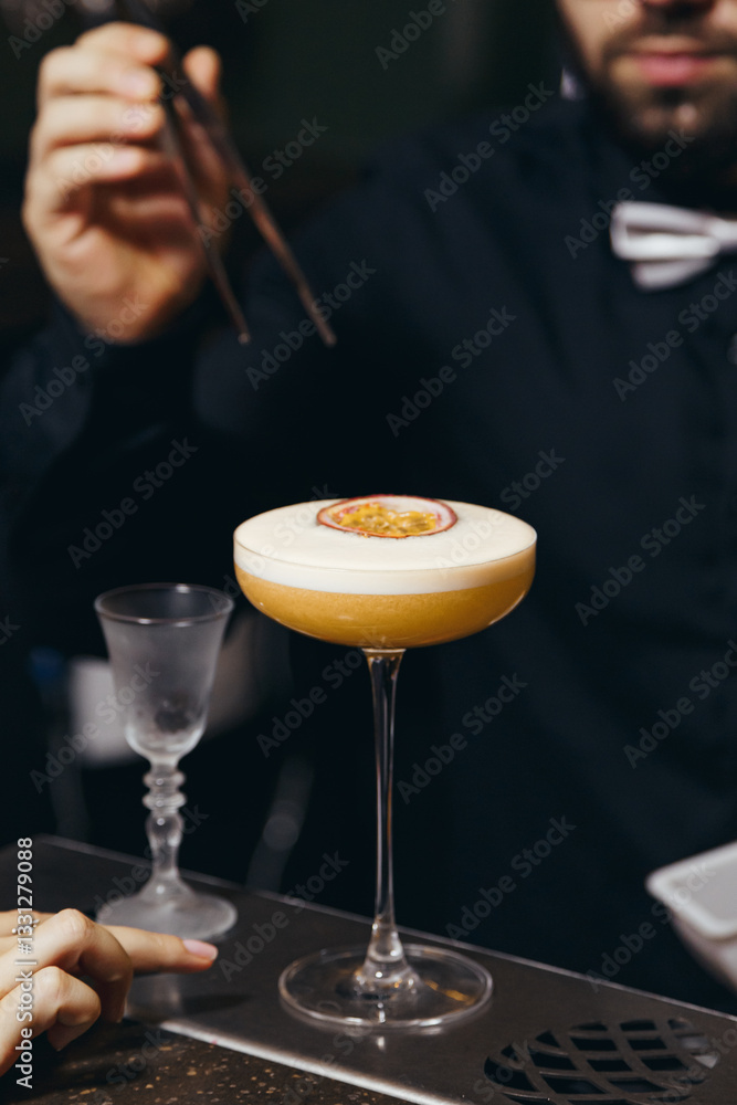 sweet and sour refreshing cocktail decorated with passion fruit on the bar counter