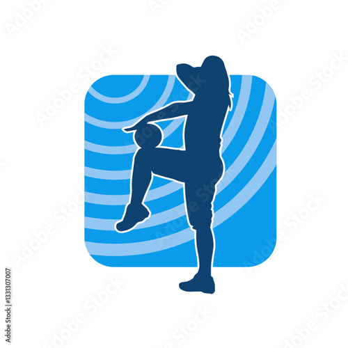 Silhouette of a slim sporty woman doing stretching exercise using gym ball. Silhouette of a sporty female doing physical workout using fitness ball. 