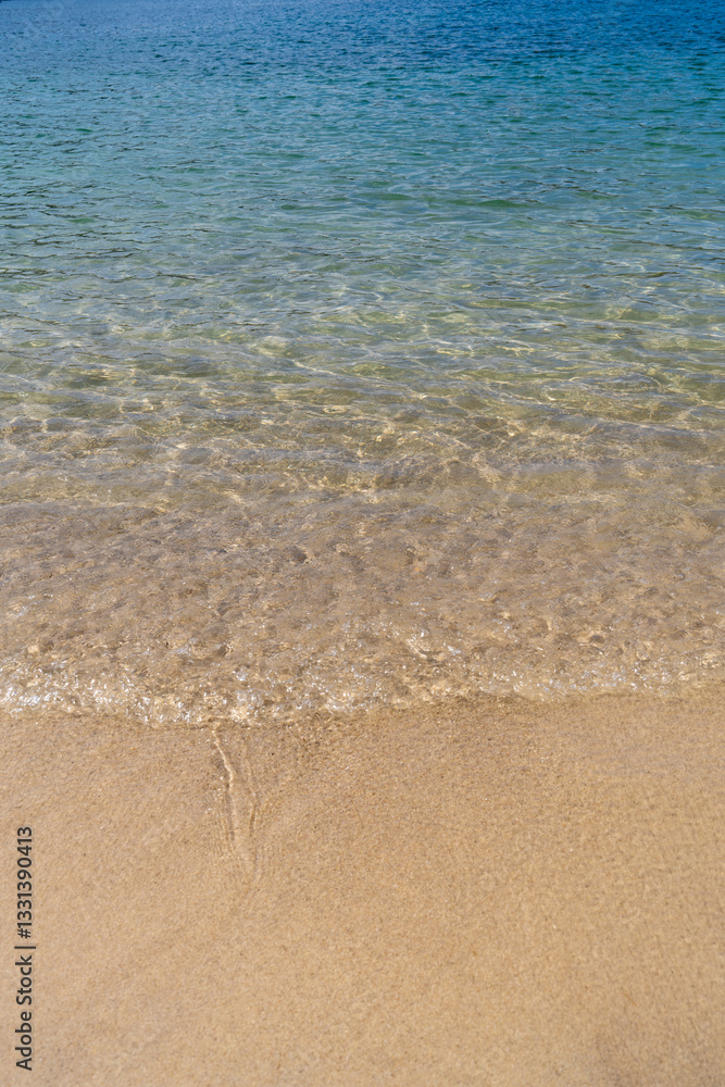 Sea waves gently rolling on golden sandy beach. Bright sunny day on beach. Concept about summer vacation. Sea waves gently rolling on golden sandy beach. Bright sunny day on beach. Concept about summer vacation.
