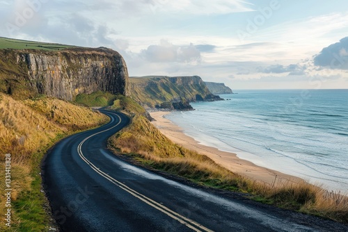 Coastal road beside beach, ocean views and cliff scenery.