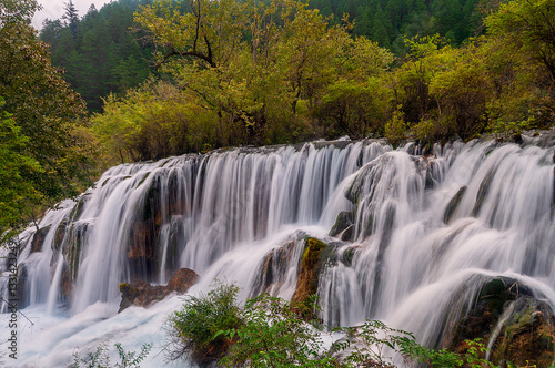 Breathtaking Cascading Suzheng Waterfall in UNESCO Jiuzhaigou Park.