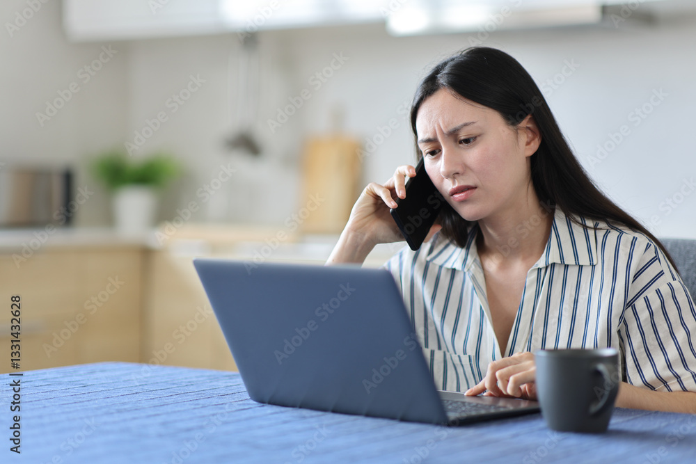 Worried asian woman using laptop and talking on phone