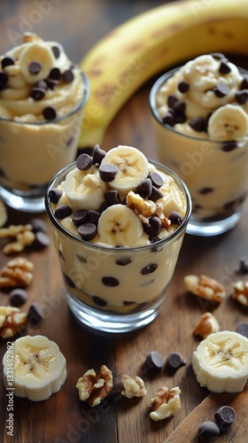 Delicious Banana Pudding Cups With Chocolate Chips and Walnuts Served on a Wo...