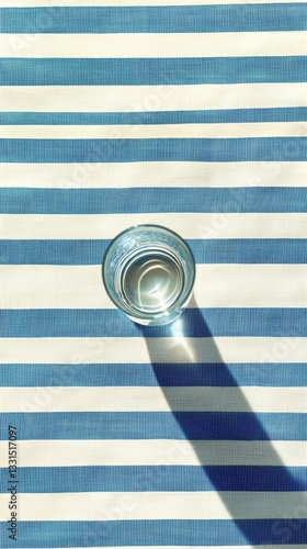 Glass of Water Placed on Striped Tablecloth in a Calming Setting During Daytime