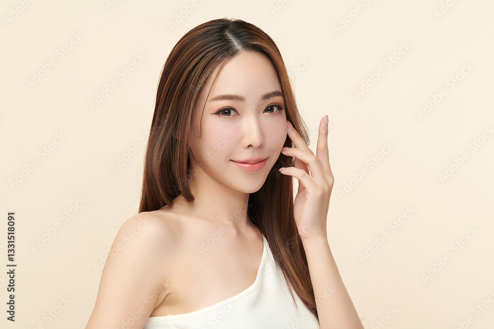 A beautiful young Asian woman with clean, fresh skin against a beige background. She represents beauty, skincare, and spa treatments. A beautiful young Asian woman with clean, fresh skin against a beige background. She represents beauty, skincare, and spa treatments.